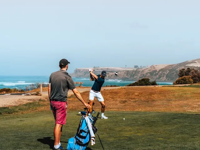 Golf instructor teaching golf to a student
